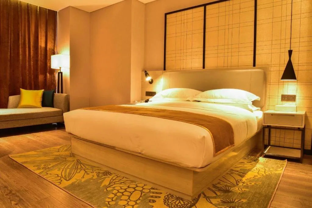 Bed in Echarm Hotel Xiantao Yuantai Weilaicheng