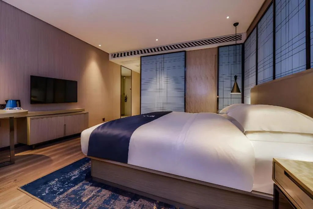 Bed in Echarm Hotel Guizhou Xingyi Jushan Avenue