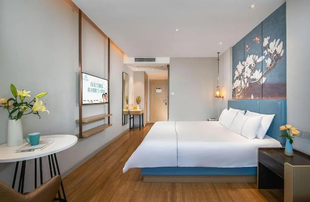 Bed in Magnotel Hotel Dongxing Guomen Port