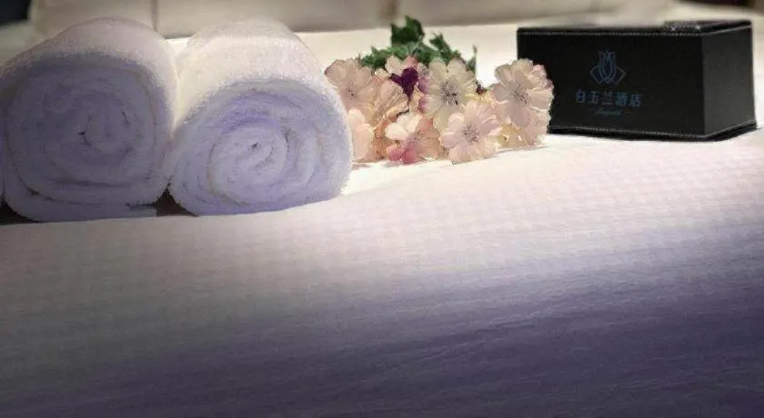 Bed in Magnotel Hotel Dongxing Guomen Port