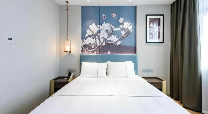 Bed in Magnotel Hotel Dongxing Guomen Port