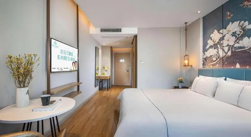 Bed in Magnotel Hotel Dongxing Guomen Port