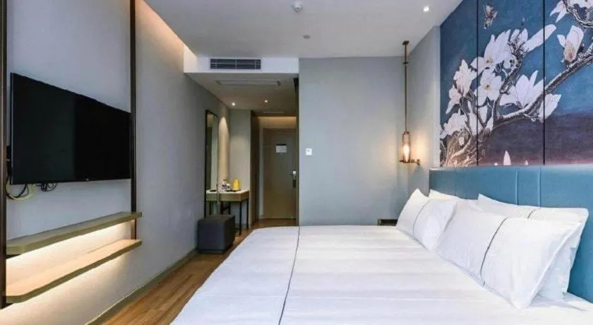 Bed in Magnotel Hotel Dongxing Guomen Port