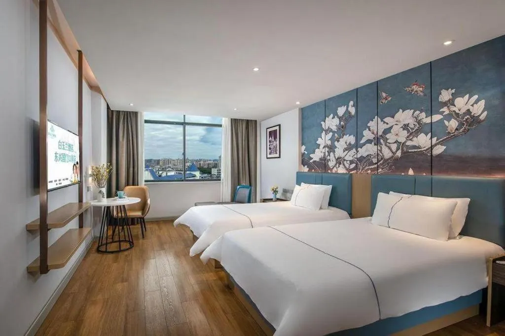 Bed in Magnotel Hotel Dongxing Guomen Port