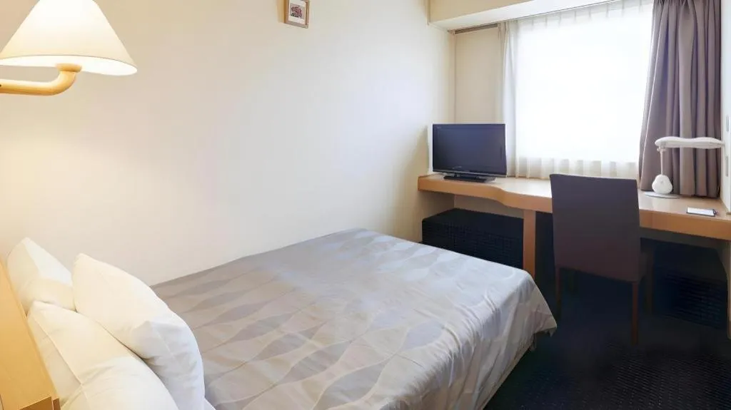 Bed in Roco Inn Matsuyama