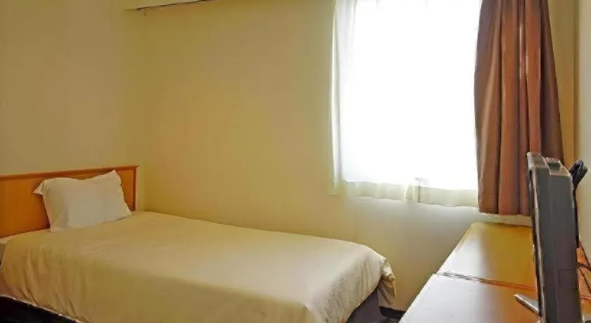 Bed in Nansei Kanko Hotel