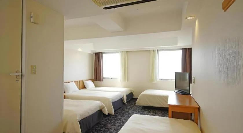 Bed in Nansei Kanko Hotel