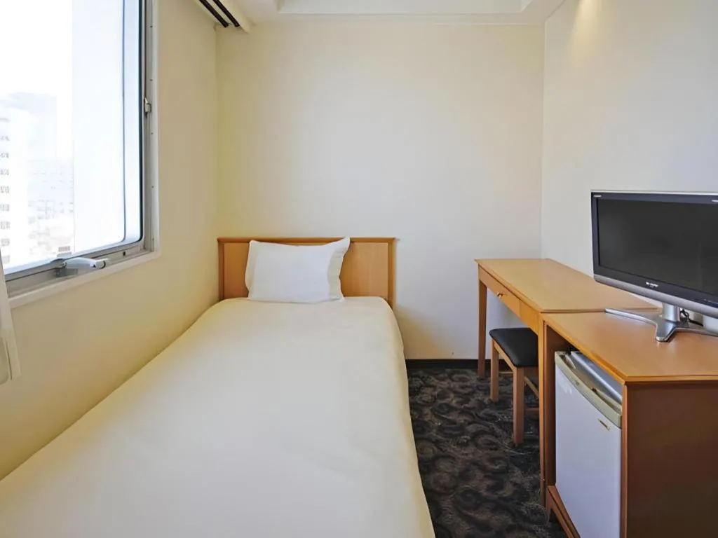 Bed in Nansei Kanko Hotel