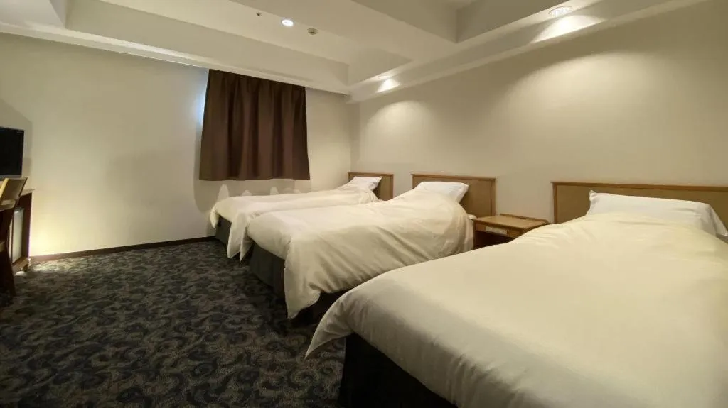 Bed in Nansei Kanko Hotel