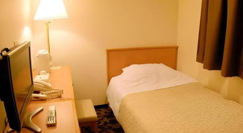 Bed in Nansei Kanko Hotel