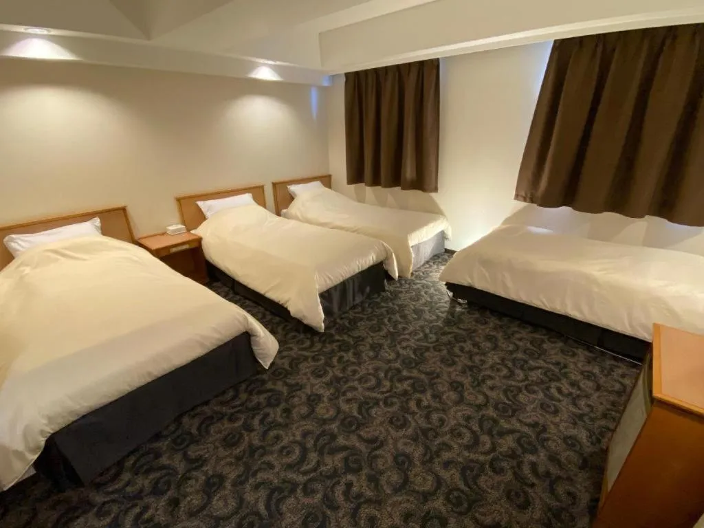 Bed in Nansei Kanko Hotel