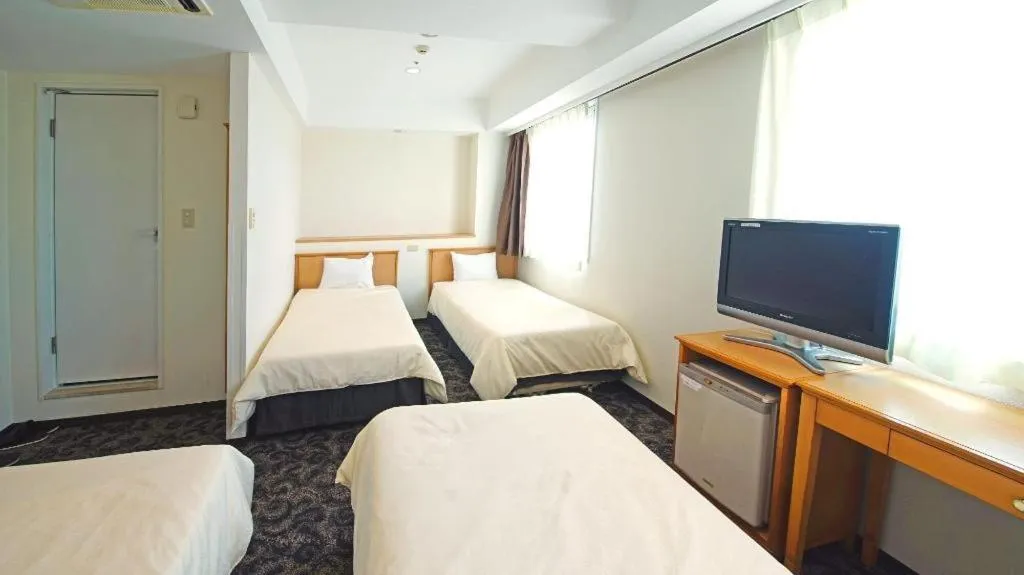 Bed in Nansei Kanko Hotel