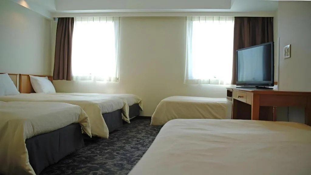 Bed in Nansei Kanko Hotel