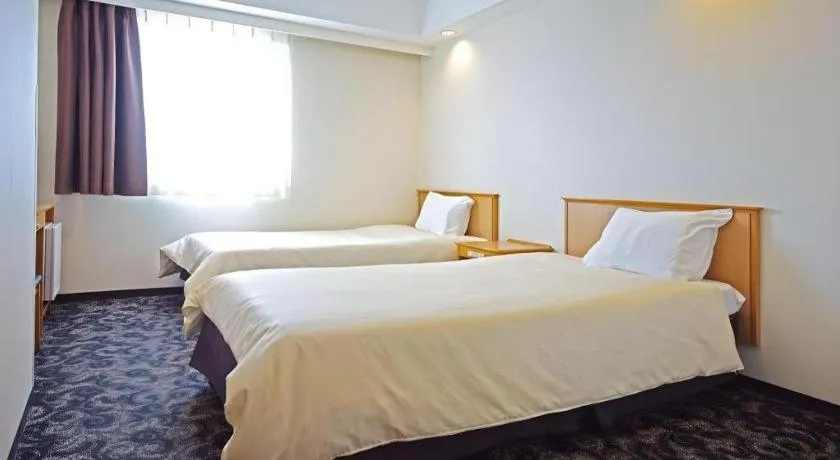Bed in Nansei Kanko Hotel