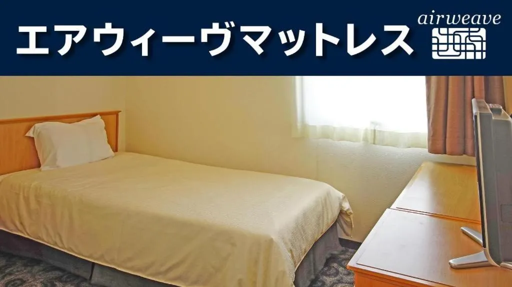 Bed in Nansei Kanko Hotel
