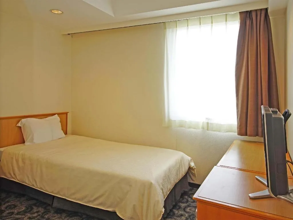 Bed in Nansei Kanko Hotel