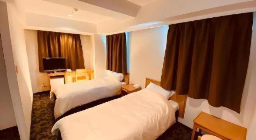 Bed in Nansei Kanko Hotel