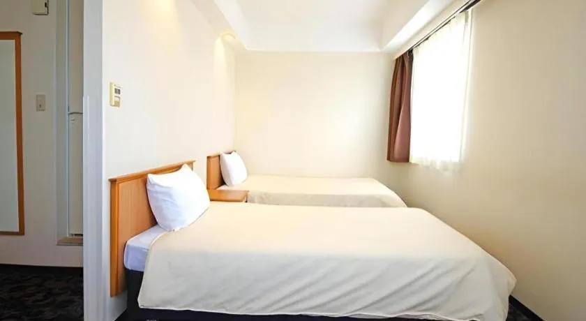 Bed in Nansei Kanko Hotel