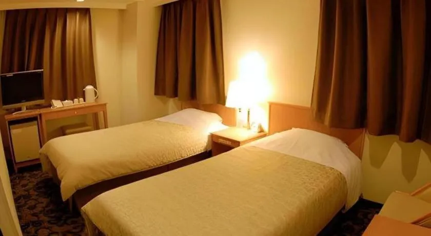 Bed in Nansei Kanko Hotel