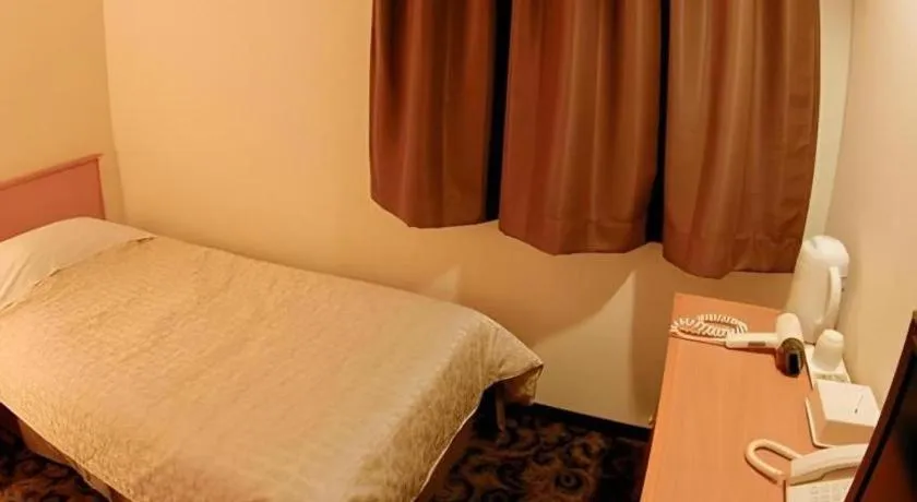 Bed in Nansei Kanko Hotel