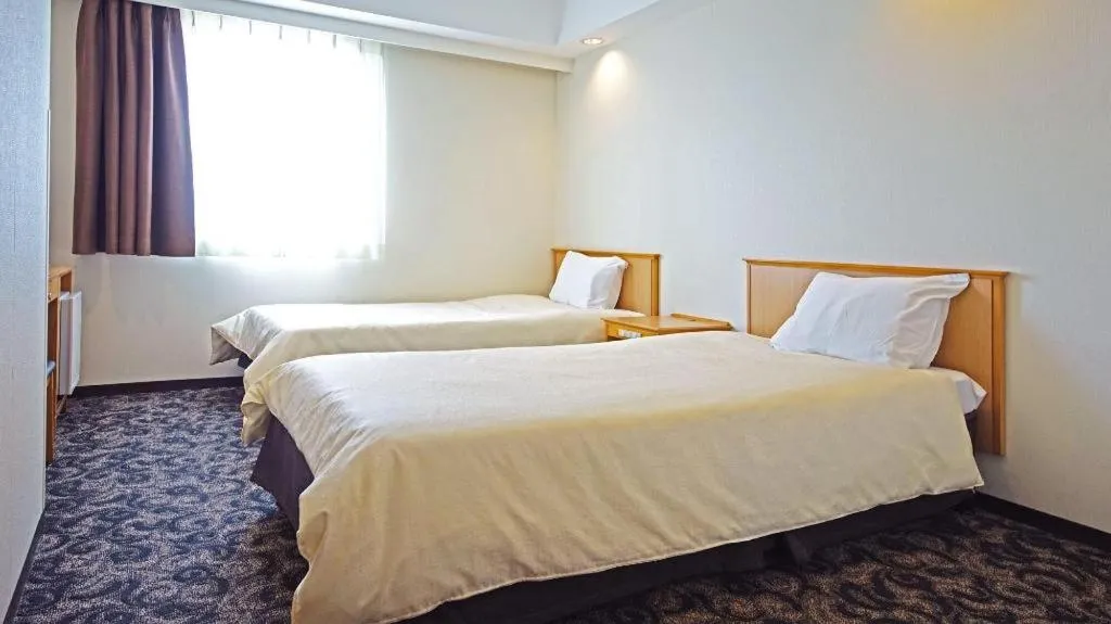 Bed in Nansei Kanko Hotel