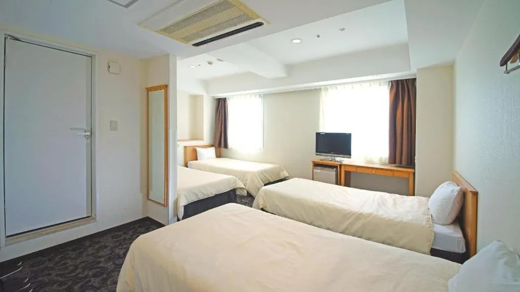 Bed in Nansei Kanko Hotel