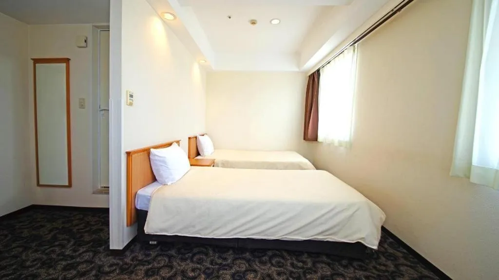 Bed in Nansei Kanko Hotel