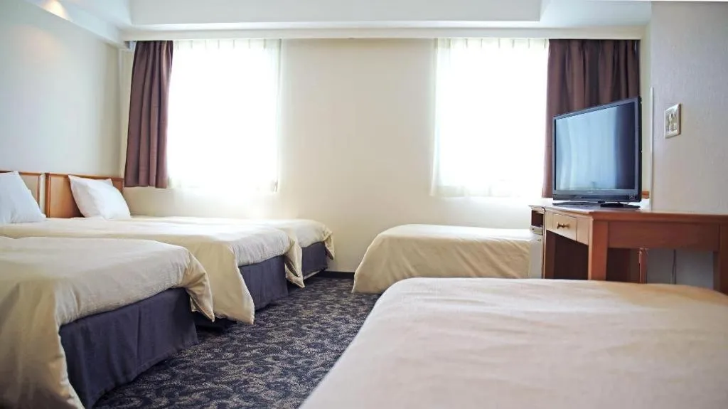 Bed in Nansei Kanko Hotel