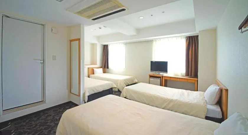 Bed in Nansei Kanko Hotel