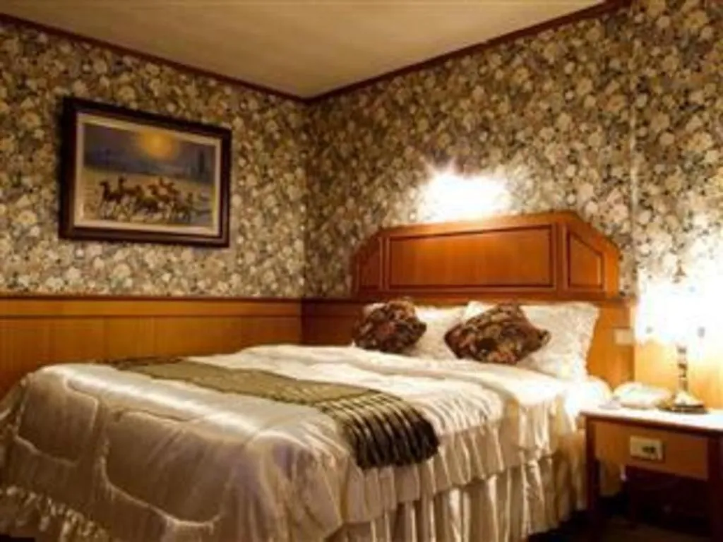 Bed in Sakol Grand Palace Hotel