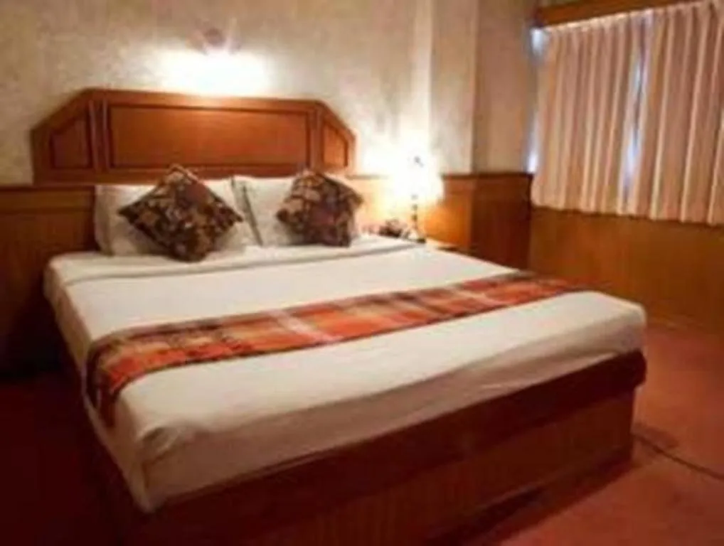 Bed in Sakol Grand Palace Hotel