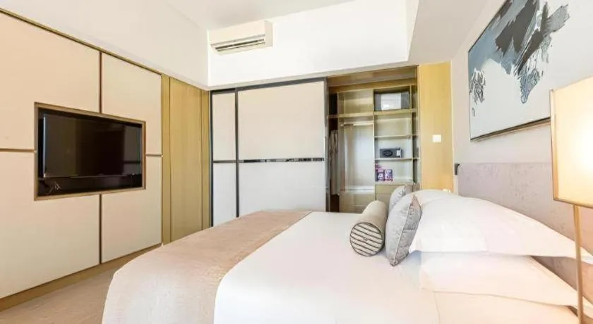 Bed in Huafa Executive Apartment Hotel Zhuhai