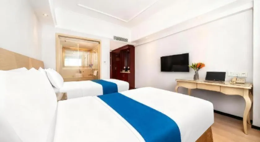 Bed in Vienna Hotel Shenzhen Pinghu Shuangyong Street Metro Station