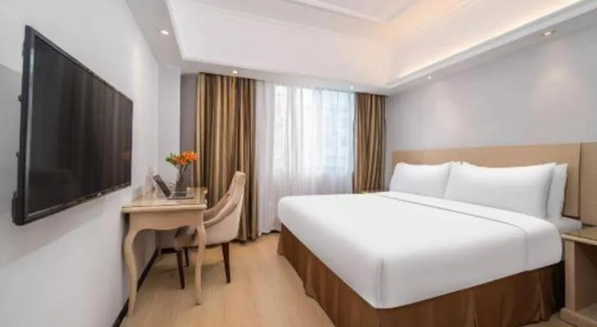 Bed in Vienna Hotel Shenzhen Pinghu Shuangyong Street Metro Station