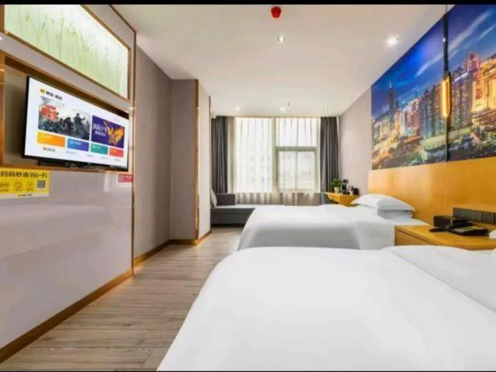 Bed in Vienna Hotel Shenzhen Pinghu Shuangyong Street Metro Station