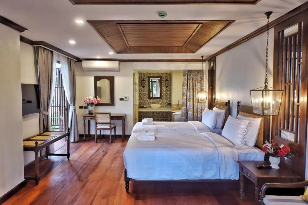 Bed in De Manor Chiang Mai Hotel