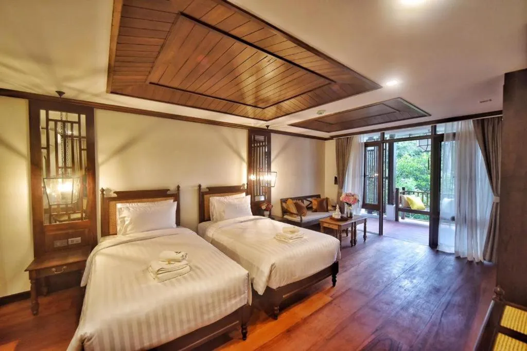 Bed in De Manor Chiang Mai Hotel