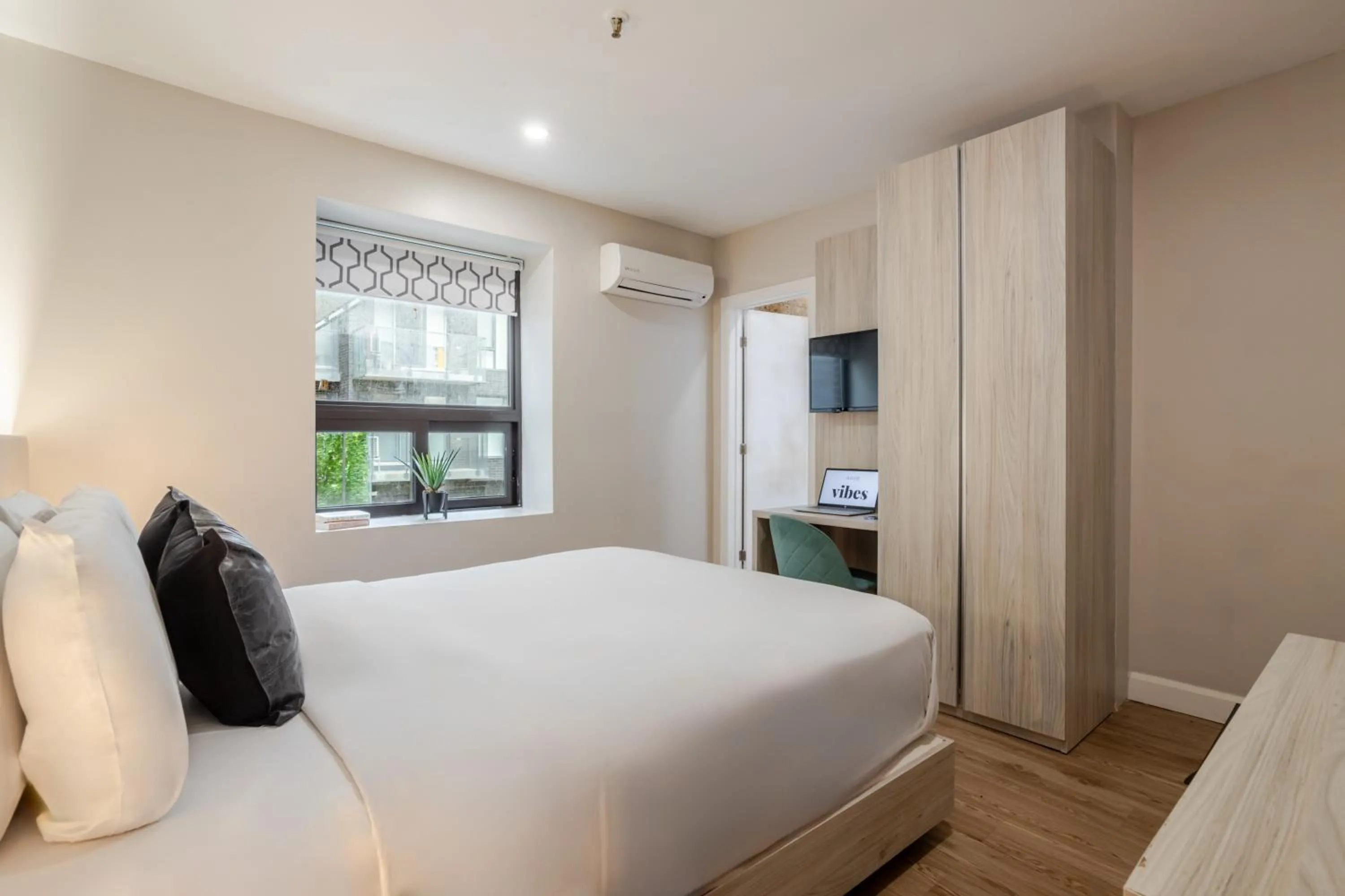 Bed in Olympia Hotel by Lodgo