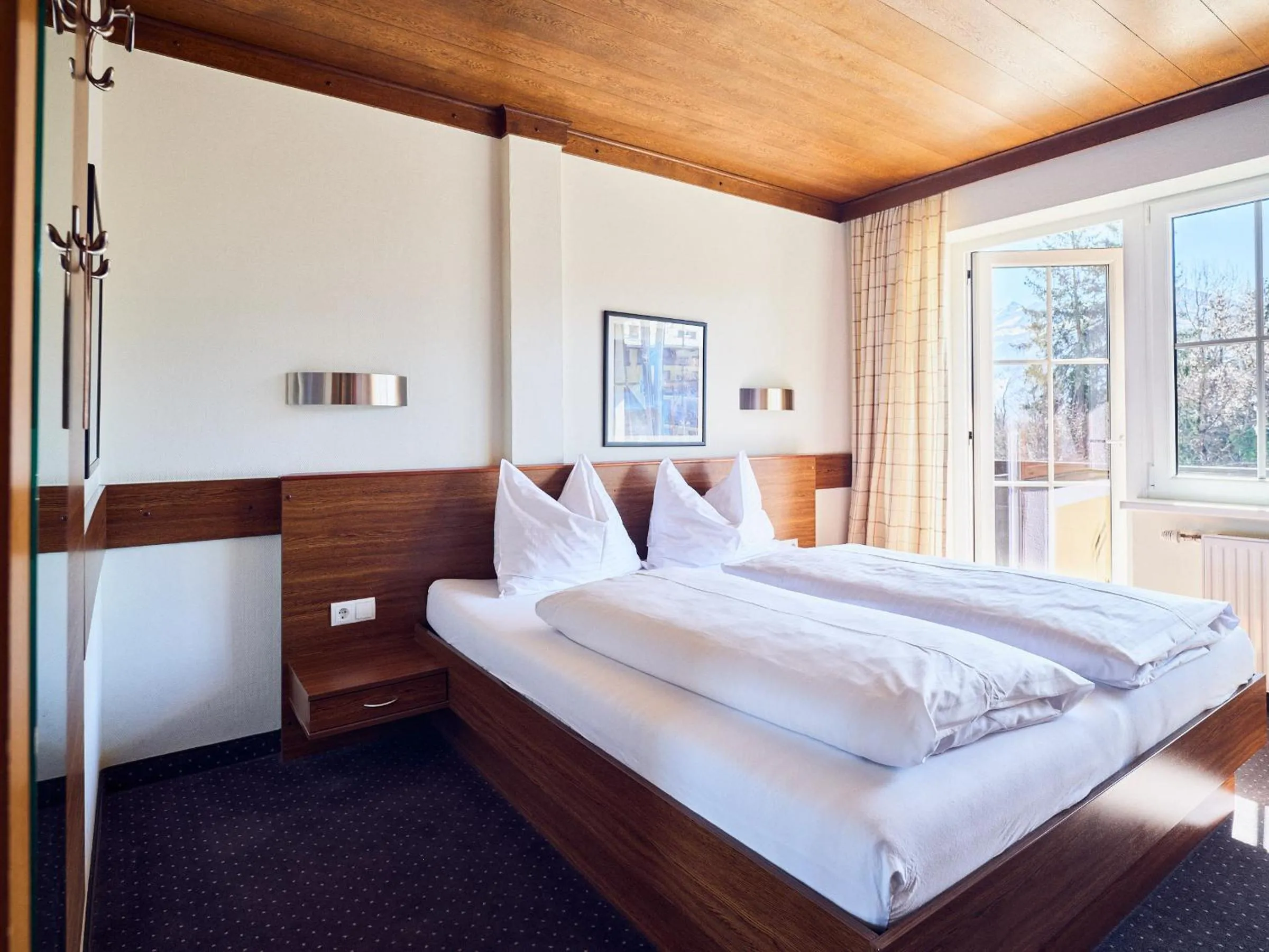 Bed in Hotel Pinzgauerhof by Alpeffect Hotels