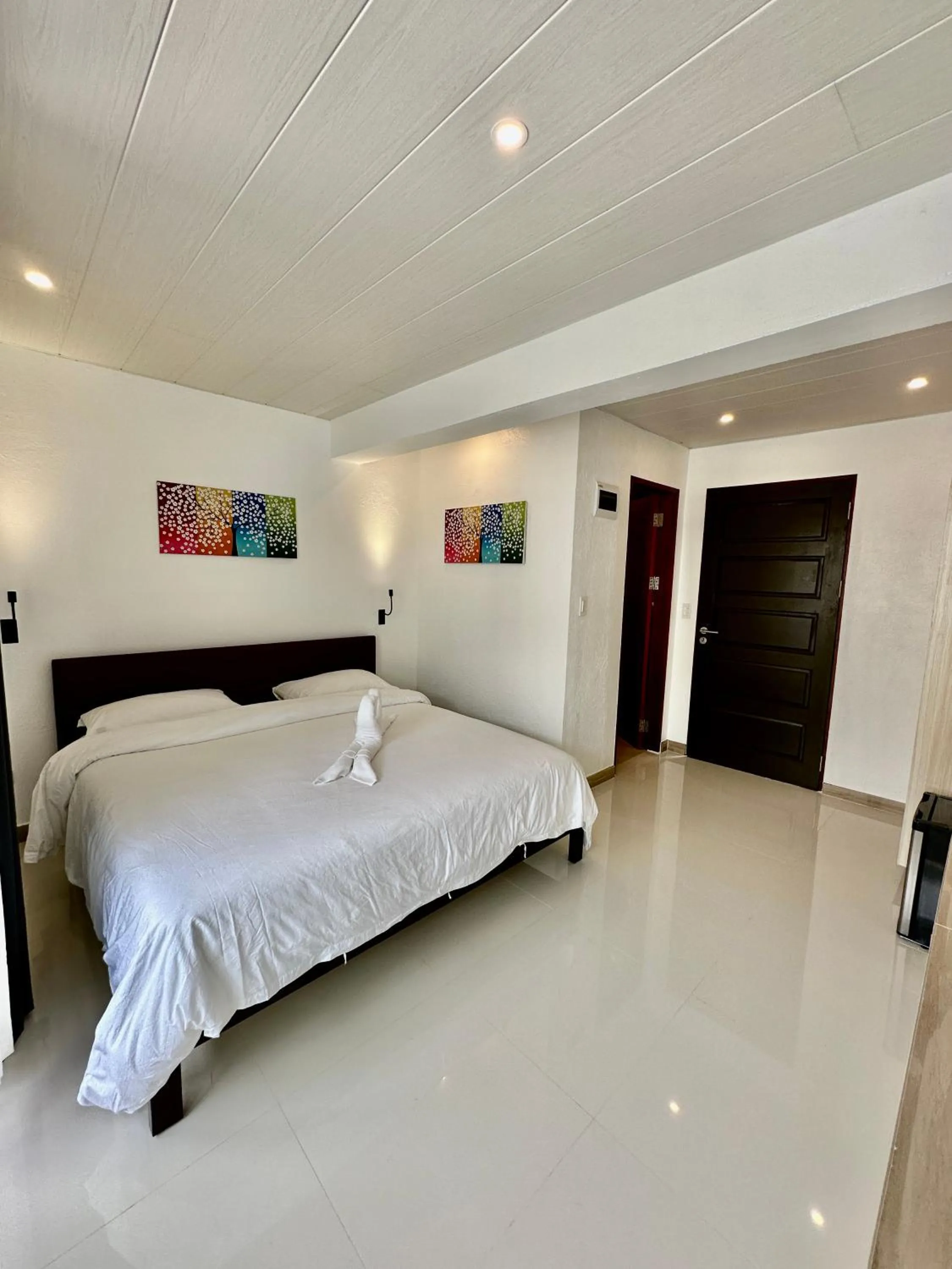 Photo of the whole room, Bed in Calypso Beach and Dive Resort