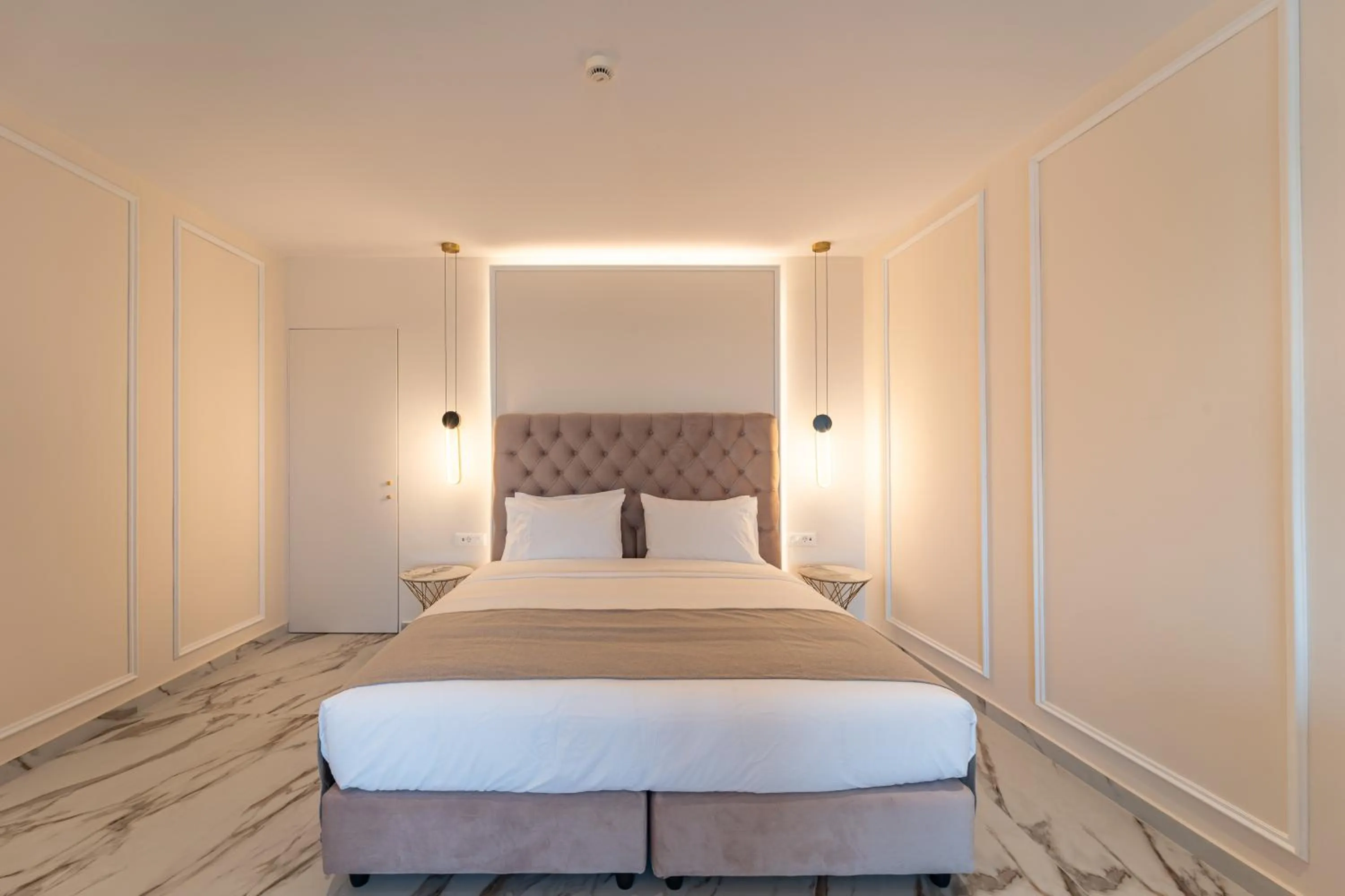 Bed in Philia Center Suites