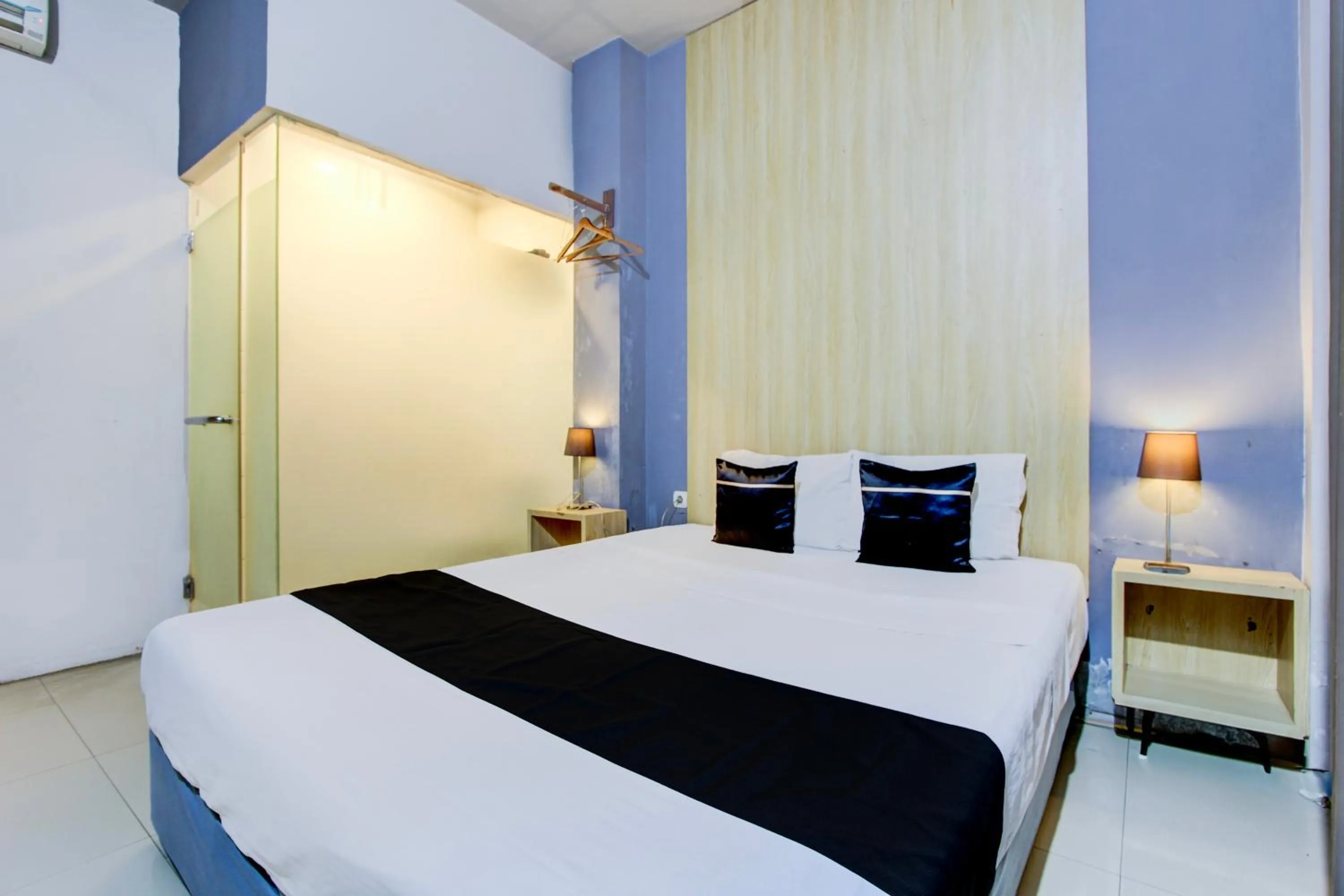 Photo of the whole room, Bed in Hotel O Tegal near near Pacific Mall Tegal formerly Hugo Suites Family