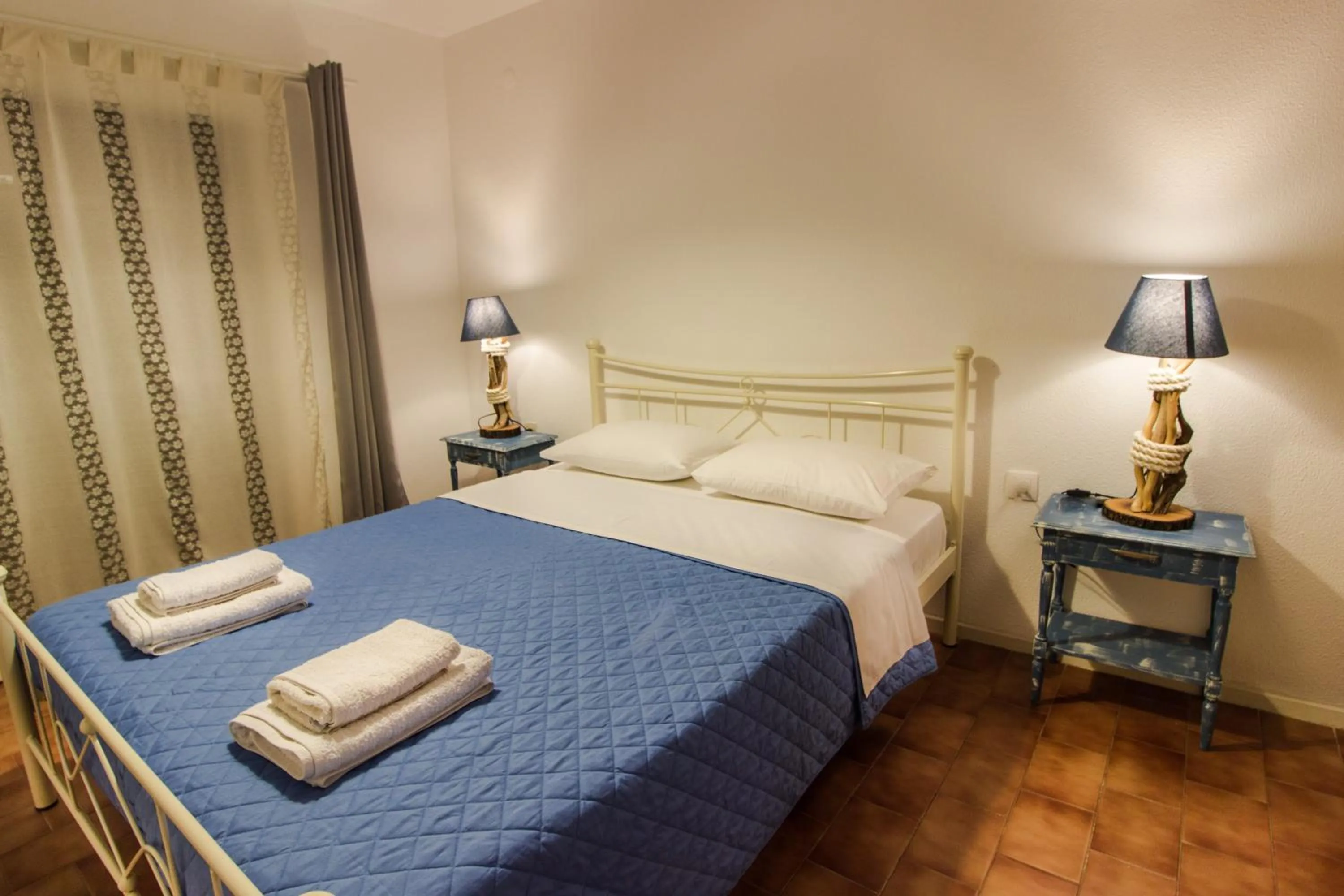 Bed in Blue Era Apartments