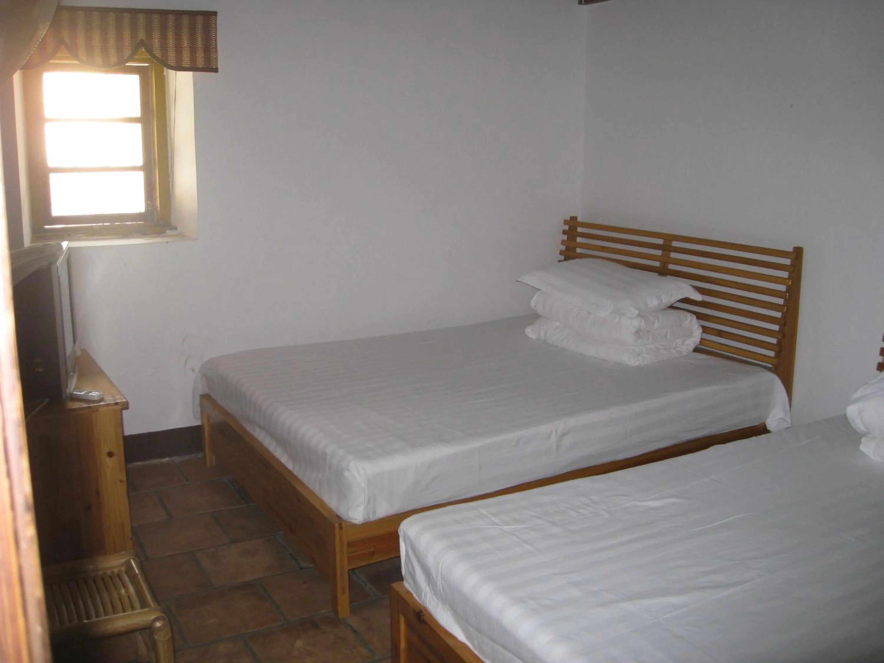 Bed in Nanjing Tulou Qingdelou Inn