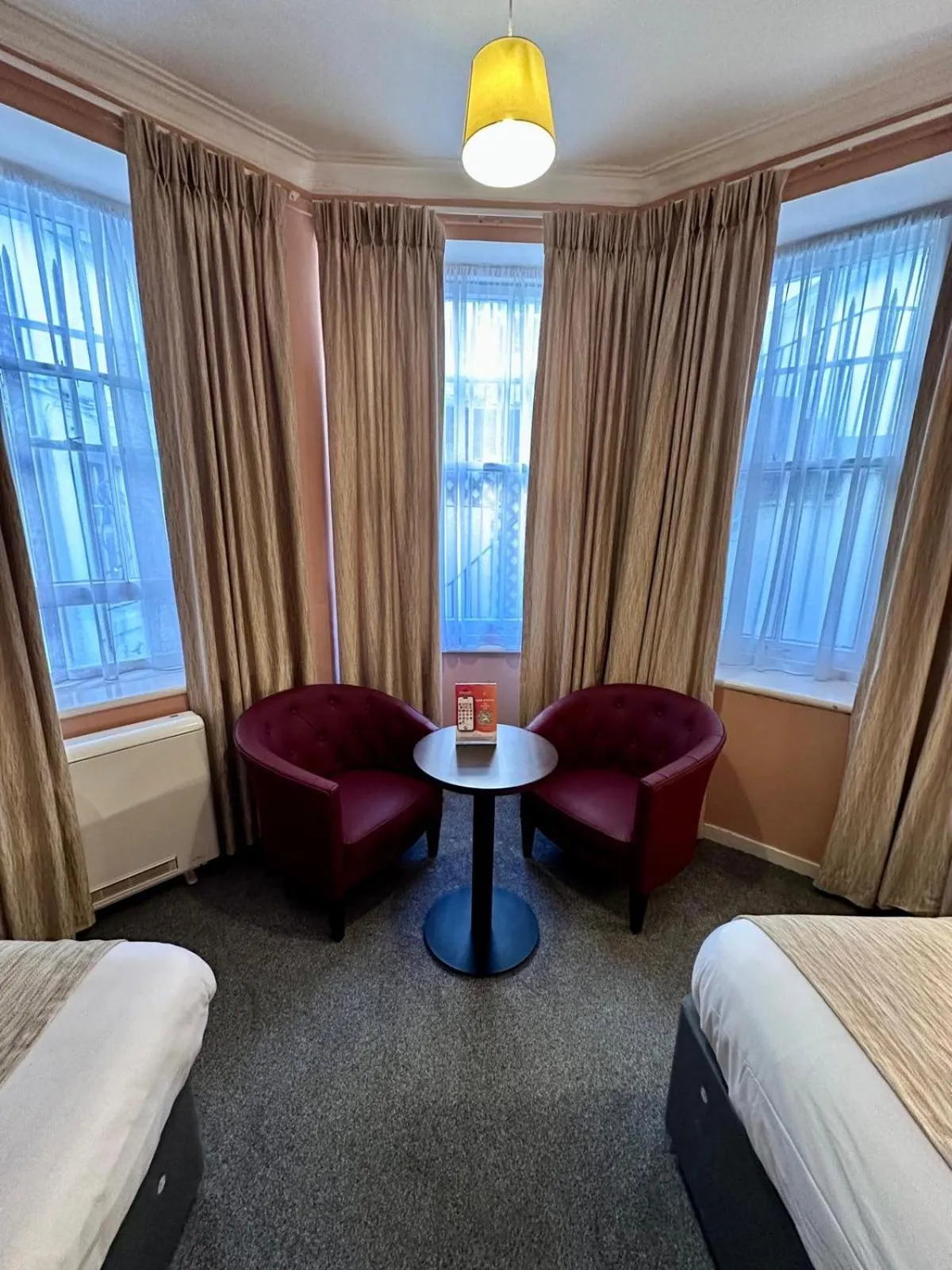 Seating area, Bed in Acacia Hotel