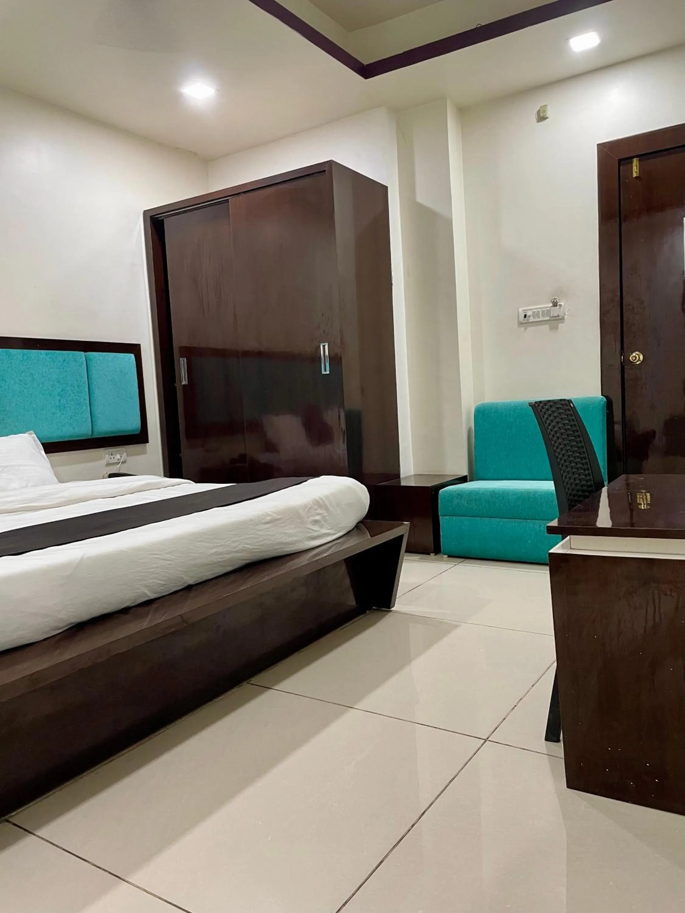 Photo of the whole room, Bed in Hotel Komal Palace Anand Nagar