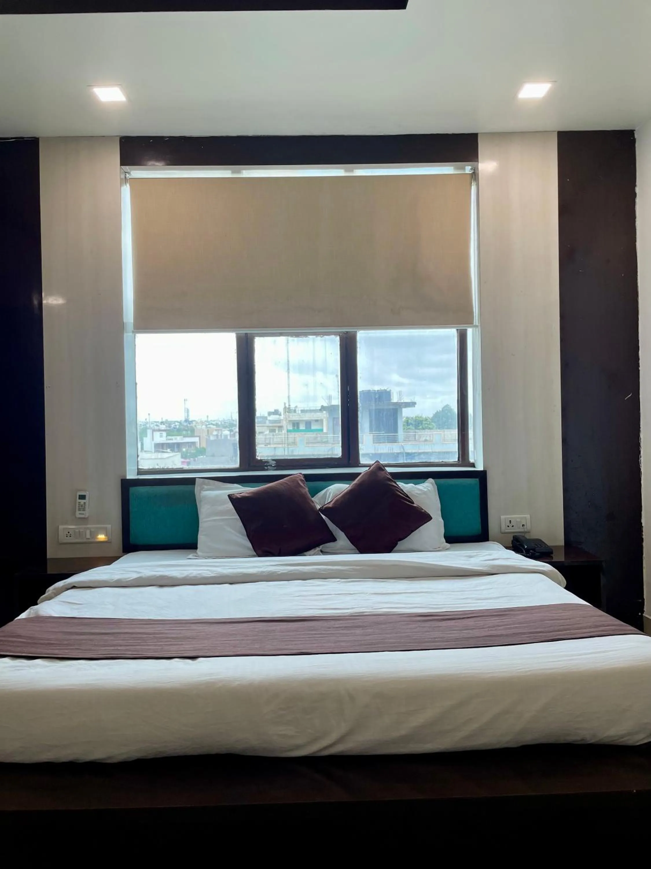 Photo of the whole room, Bed in Hotel Komal Palace Anand Nagar