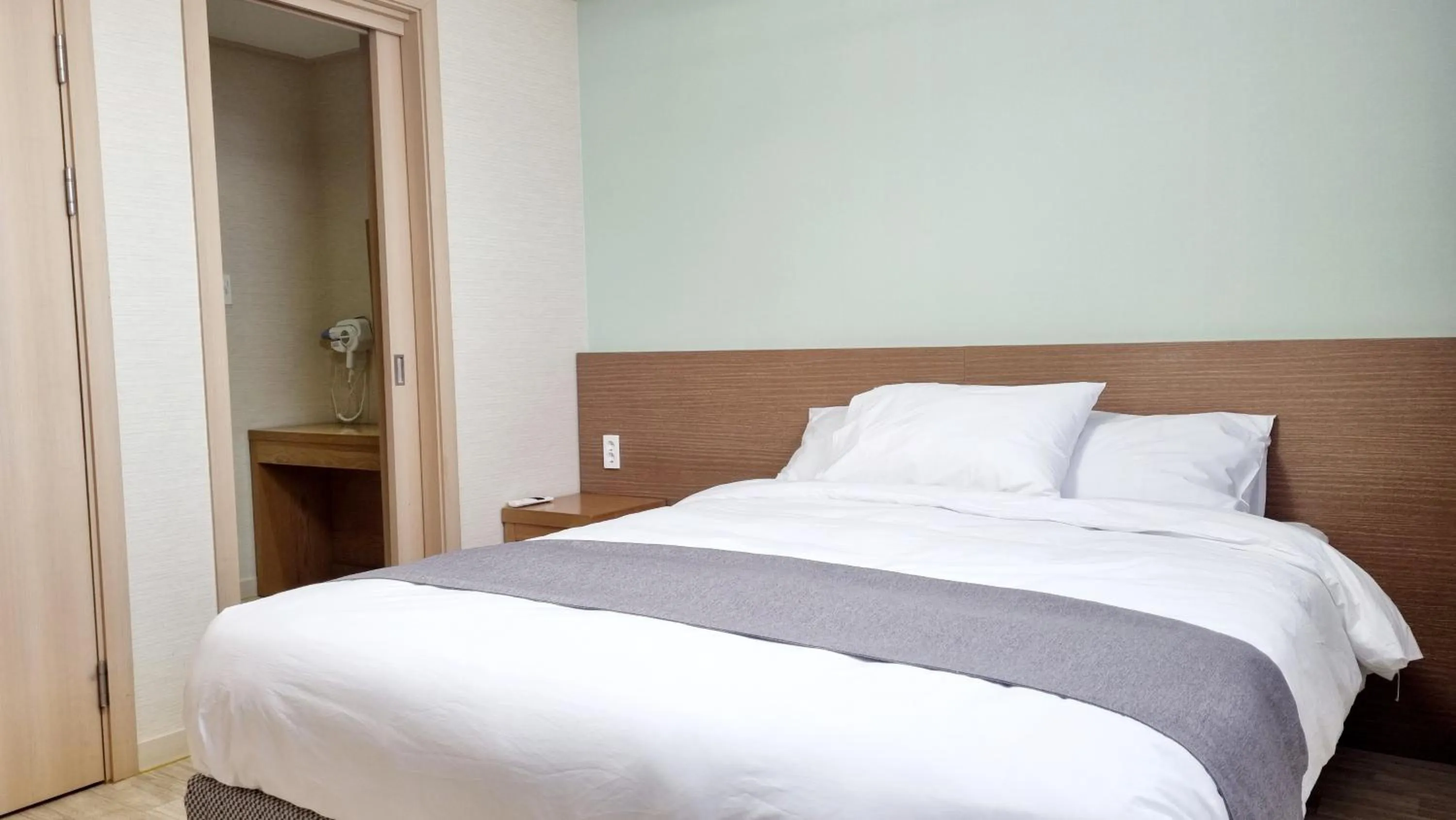 Bed in Hi Jeju Hotel