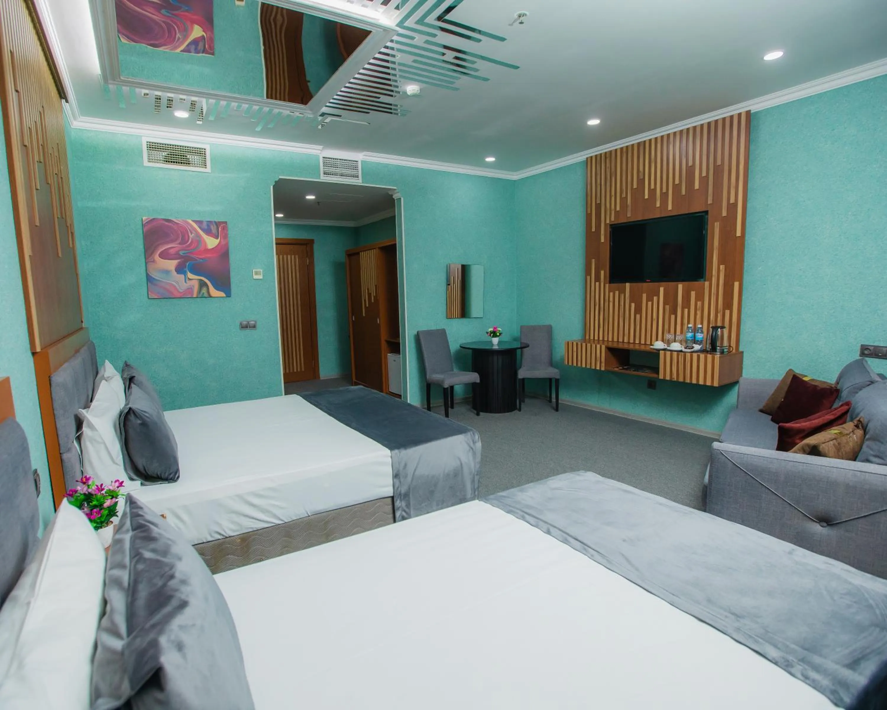 Communal lounge/ TV room, Bed in Corniche White City Hotel