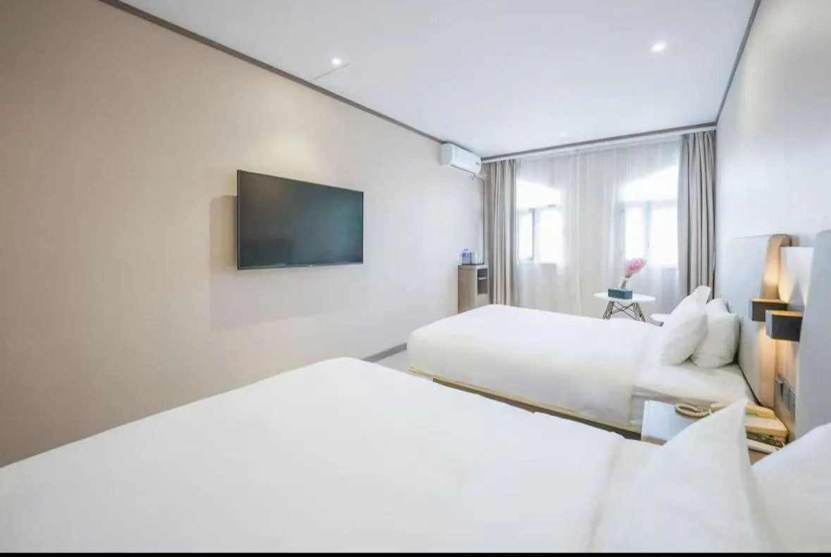 Bed in Hanting Hotel Shanghai Songjiang Sijing